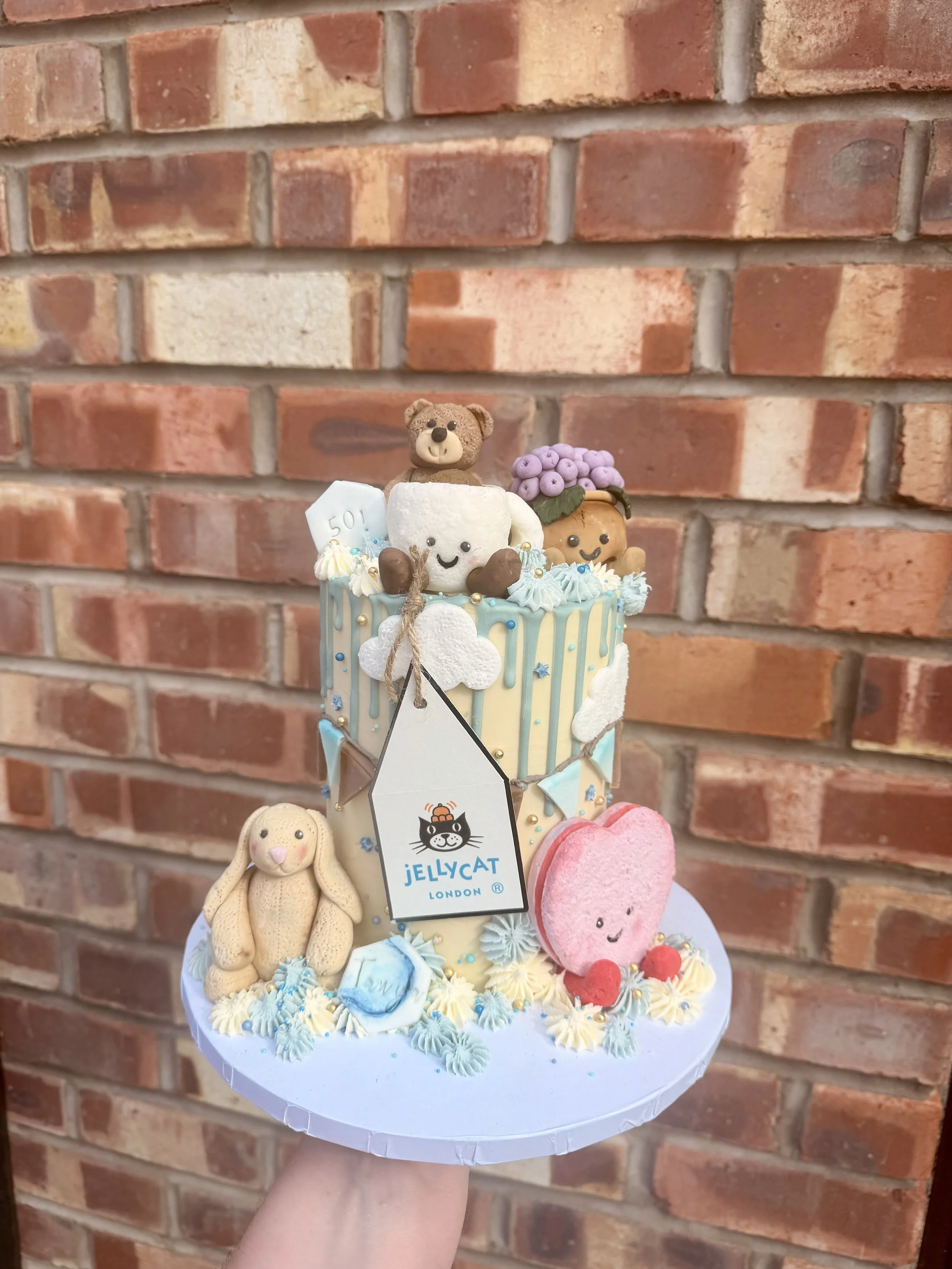 Pastel Jellycat themed birthday cake with personalised character decorations