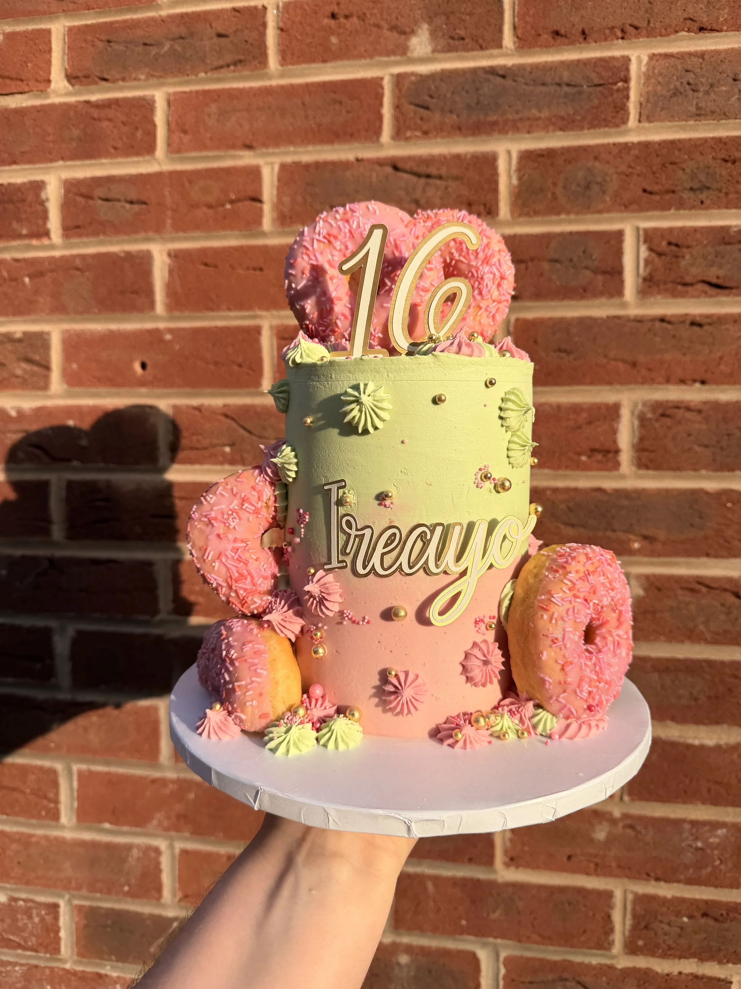 Pink, Mint Green and Gold bespoke 16th birthday cake with pink doughnut decorations