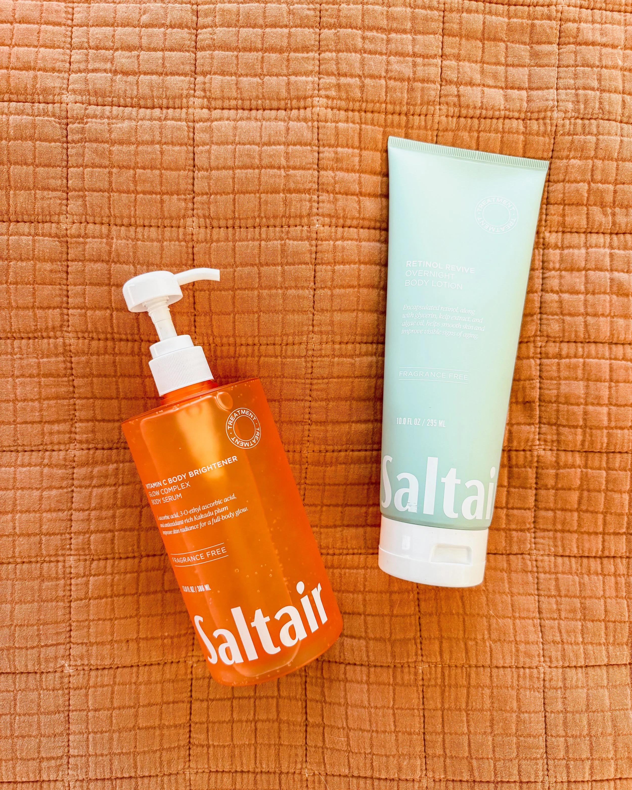 Woman's shower and post-shower body care routine featuring Tree Hut Tropic Glow, Naturium body wash, Saltair body oil, eos Vanilla Cashmere lotion, and Ouai leave-in conditioner.