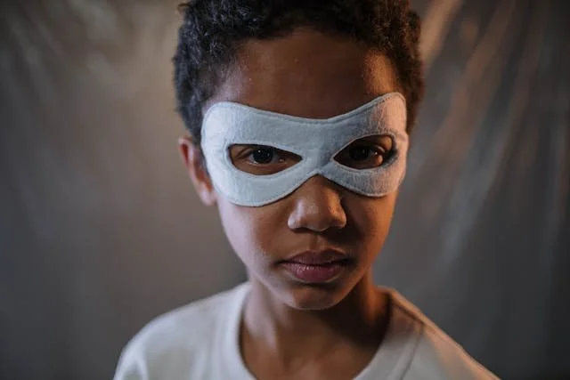 A Boy Wearing a White Mask in Close-up Shot