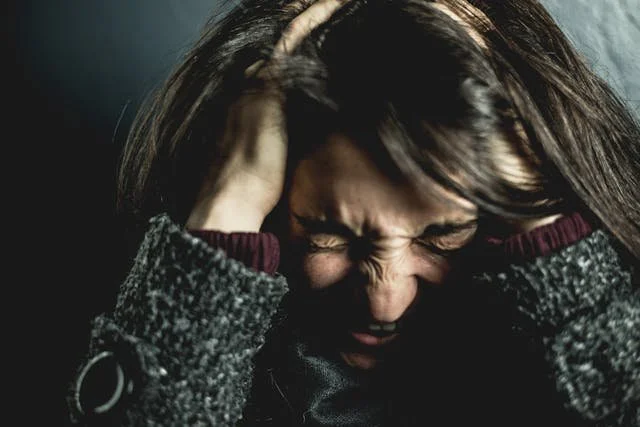 woman with head in hands