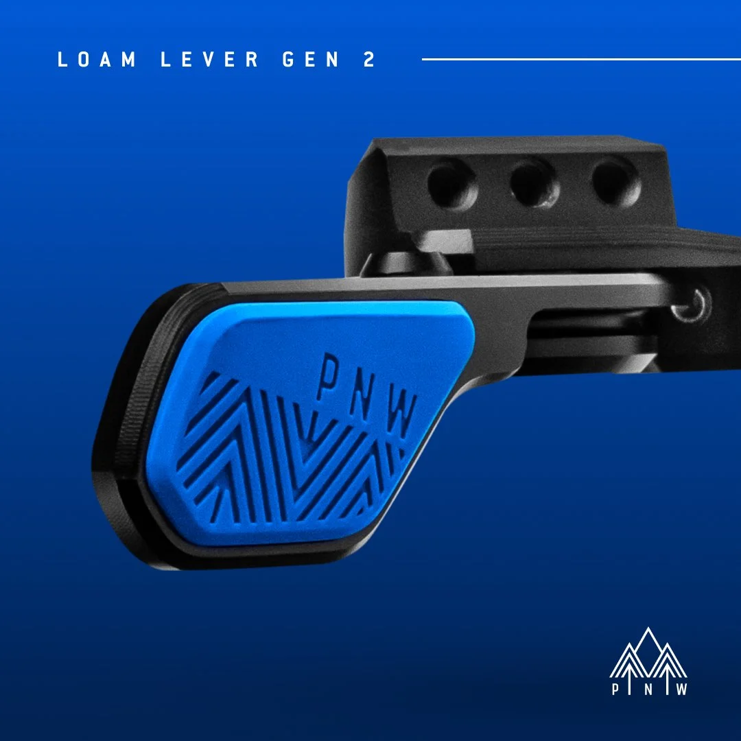 Close-up of a black and blue mechanical component labeled 'LOAM LEVER GEN 2' with the PNW logo in the bottom right corner, against a blue background.