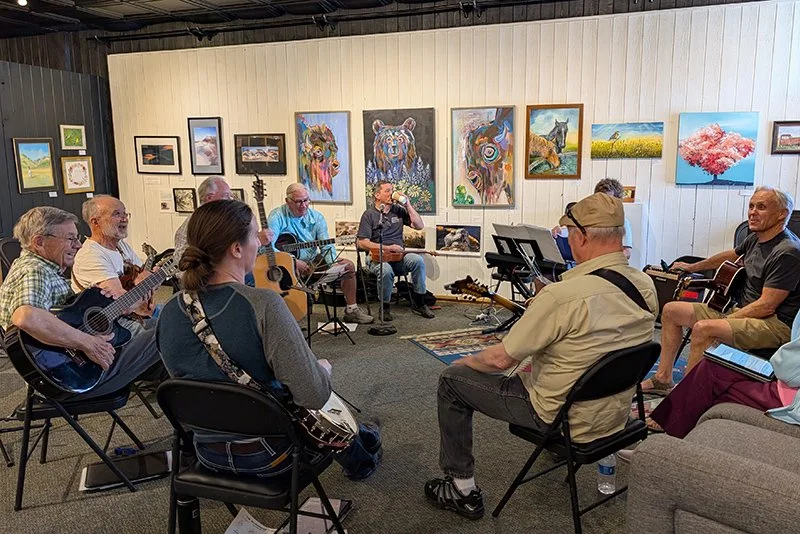 People playing guitars and singing in the gallery