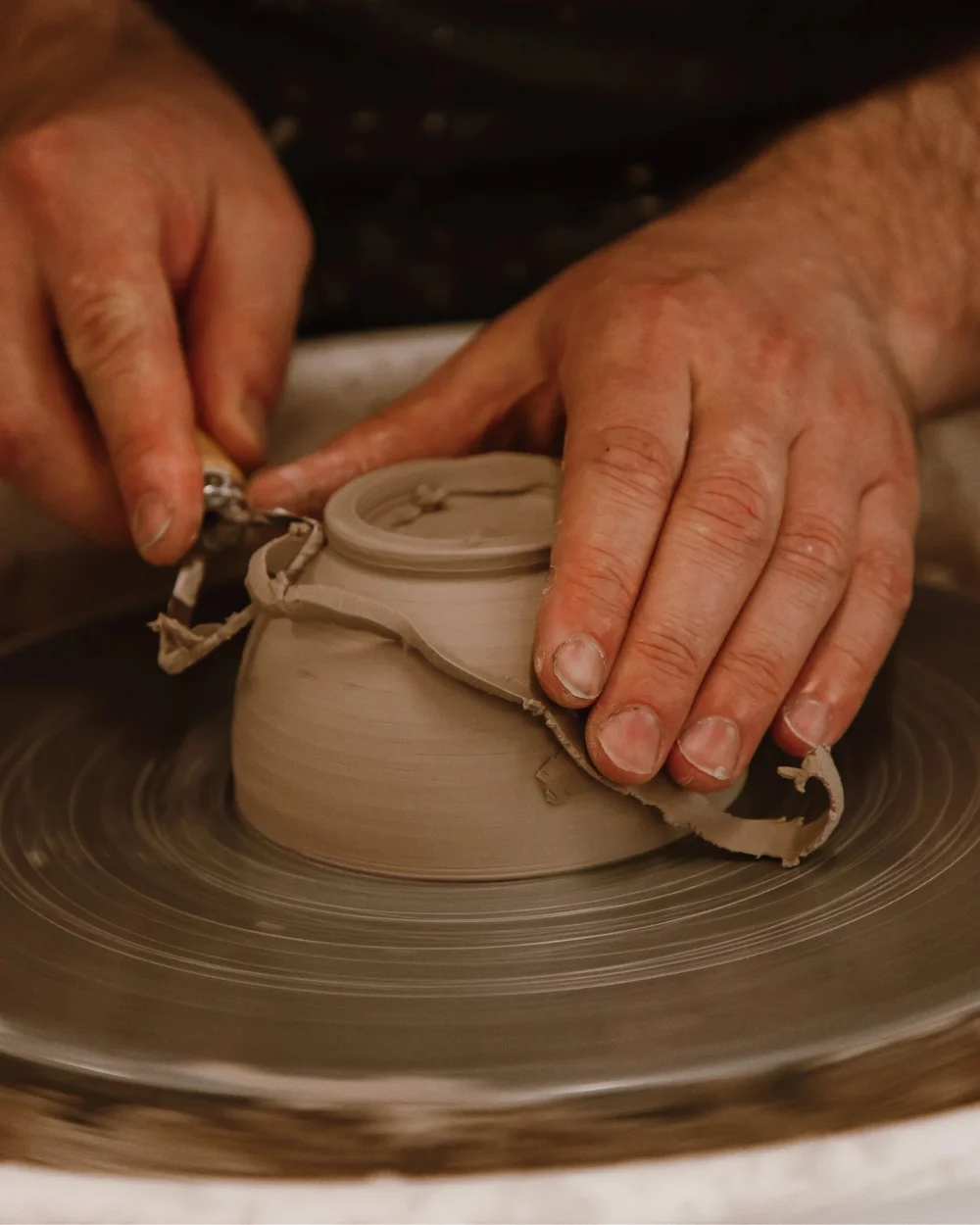 Hands shaping clay