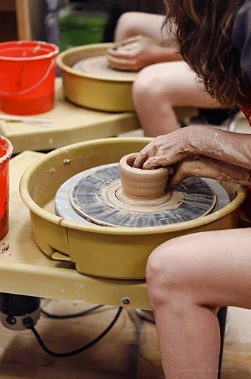 Throwing a pot on the wheel in the clay studio
