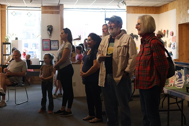 Adults and children gathered together at an LAC event