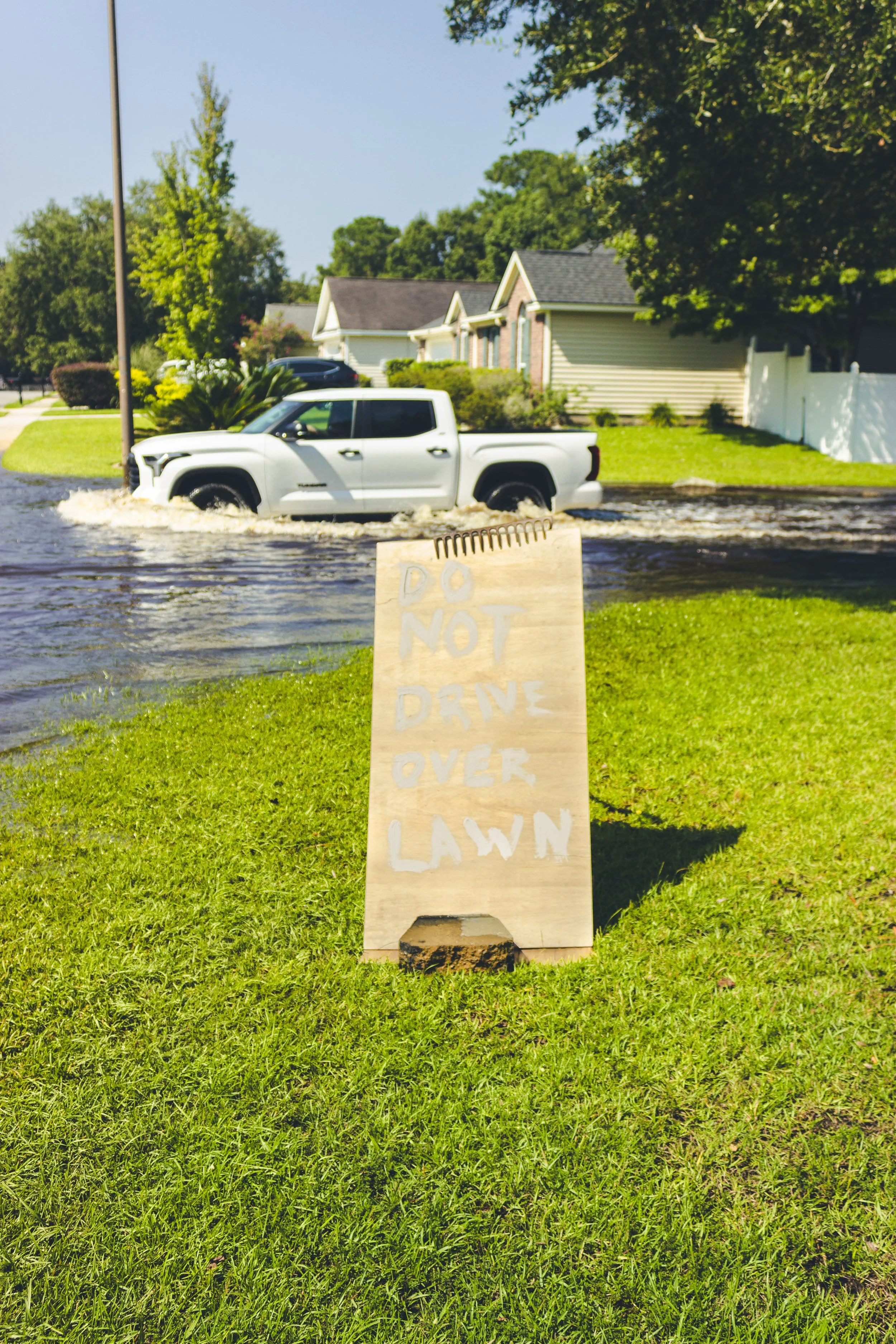 A sign put up by a resident saying “Do Not Drive Over Lawn”