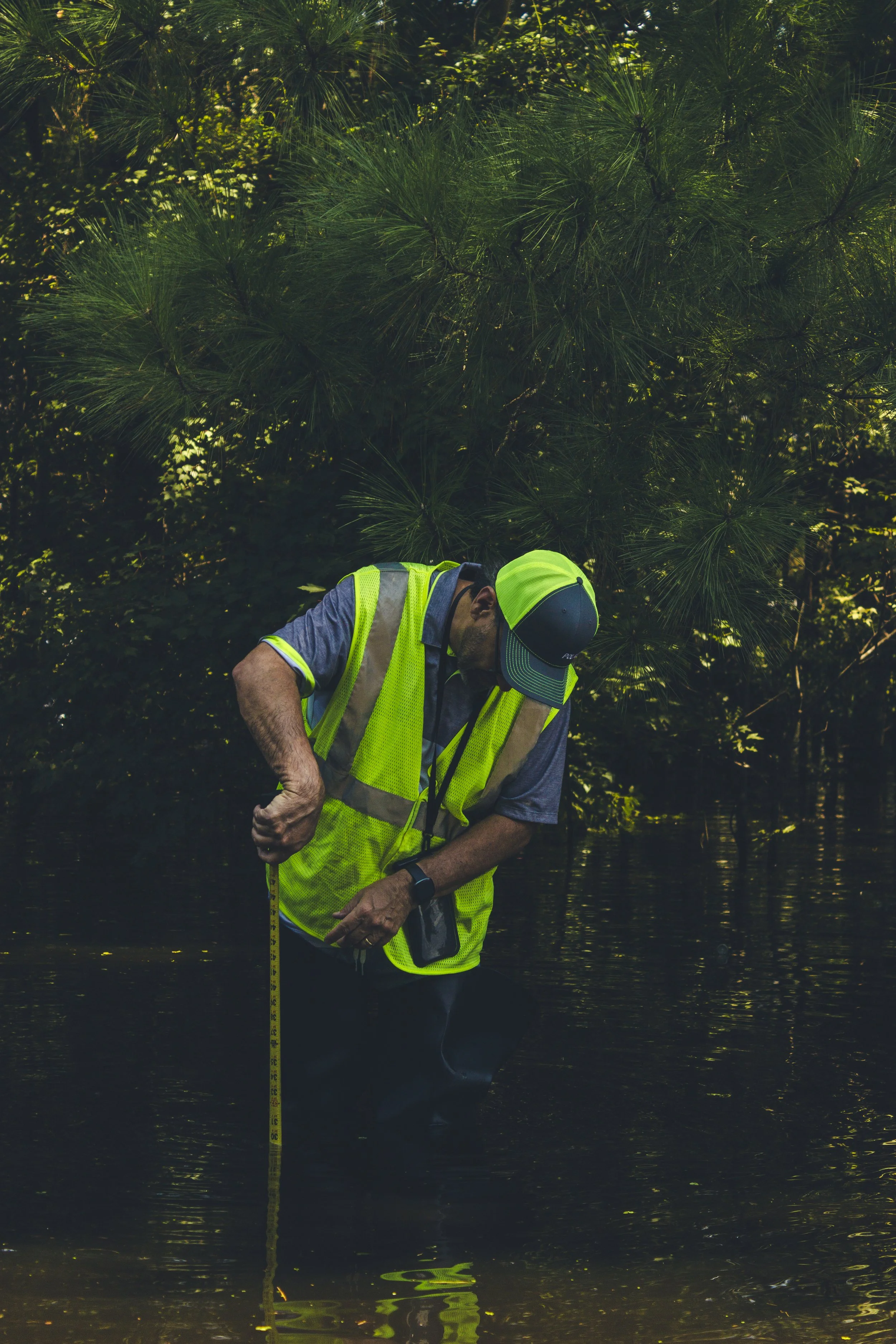 A Savannah city worker checking the depth of the water on Bradley Boulevard