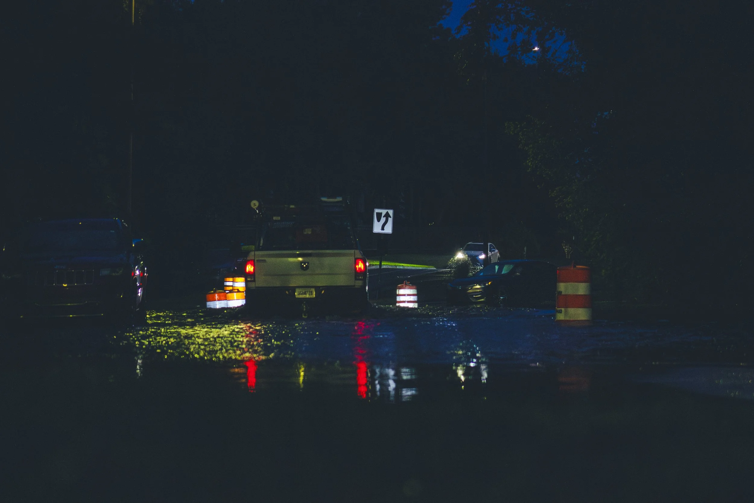 Truck plowing through the water at night