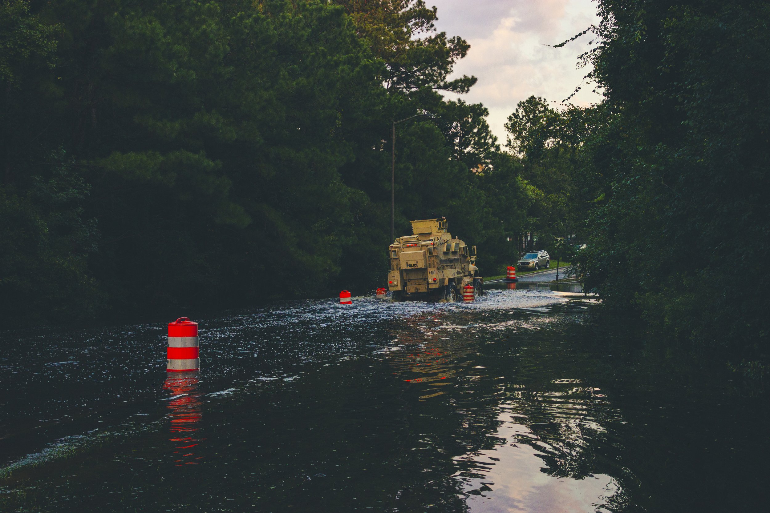 The military-grade police unit plowing through the water at sunset on Bradley Boulevard