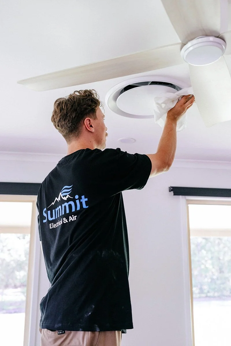 Air conditioning technician installing ducted air conditioning system