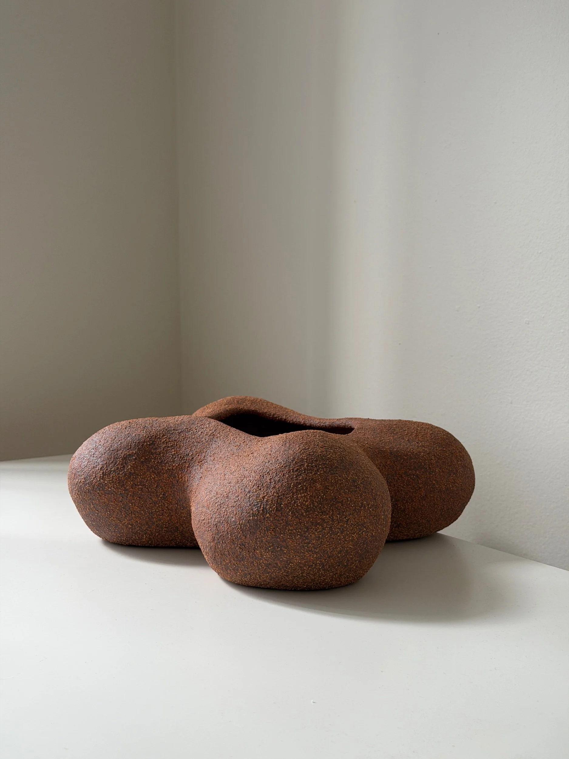 contemporary sculptural vessel with volcanic texture and organic shape