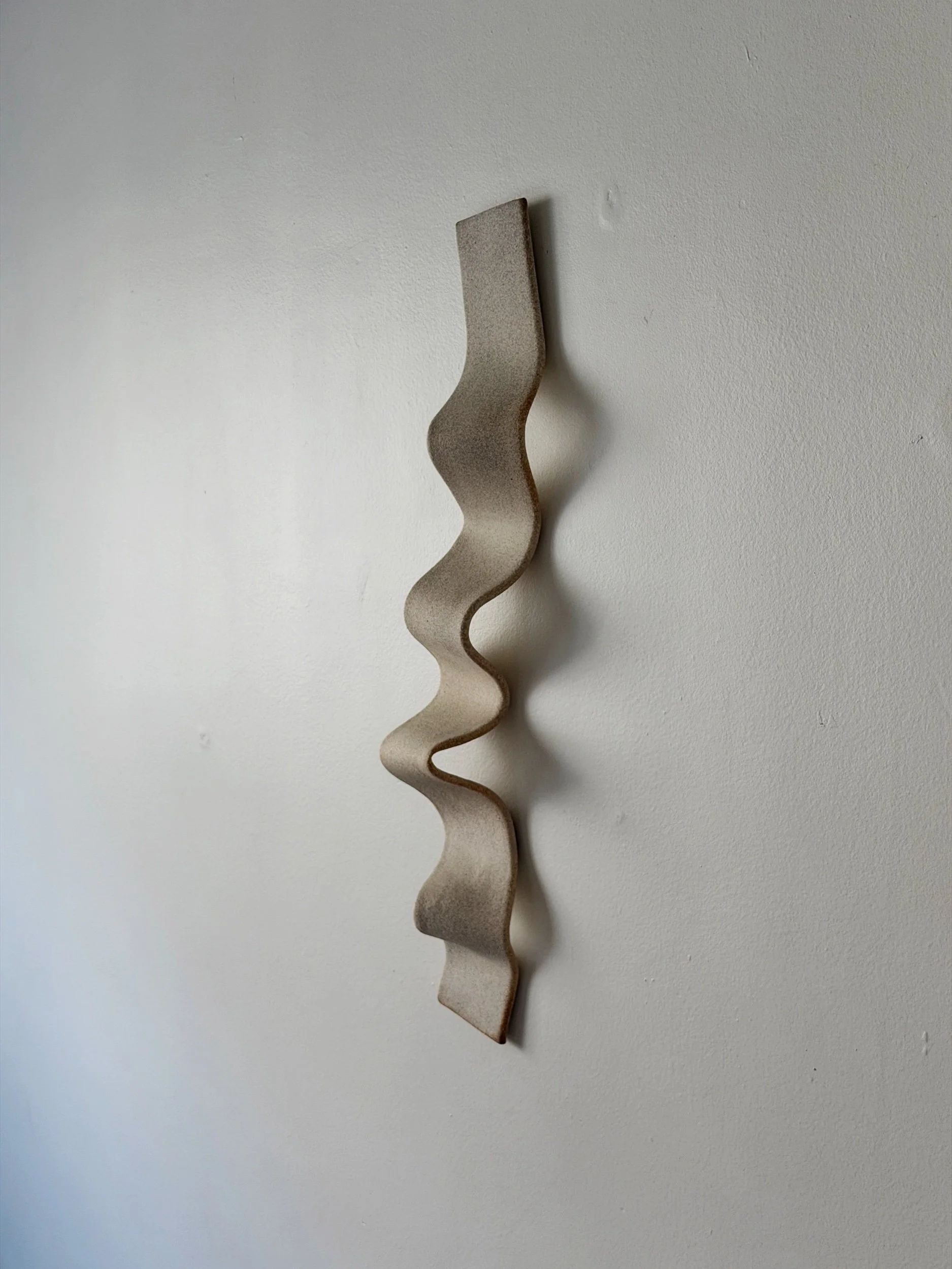 Ceramic wall sculpture in natural clay. Minimal design.