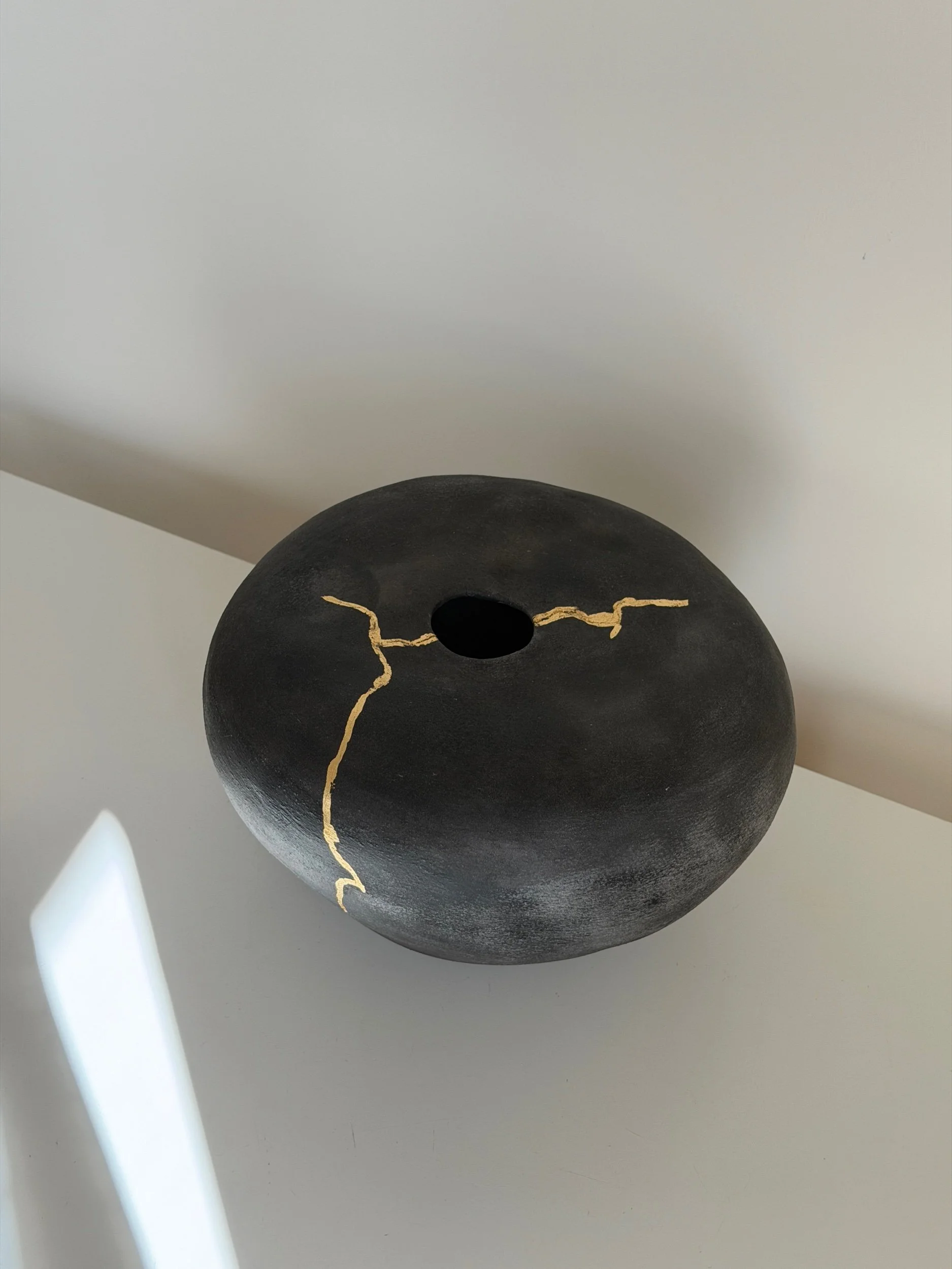 black handmade ceramic vase with gold detail