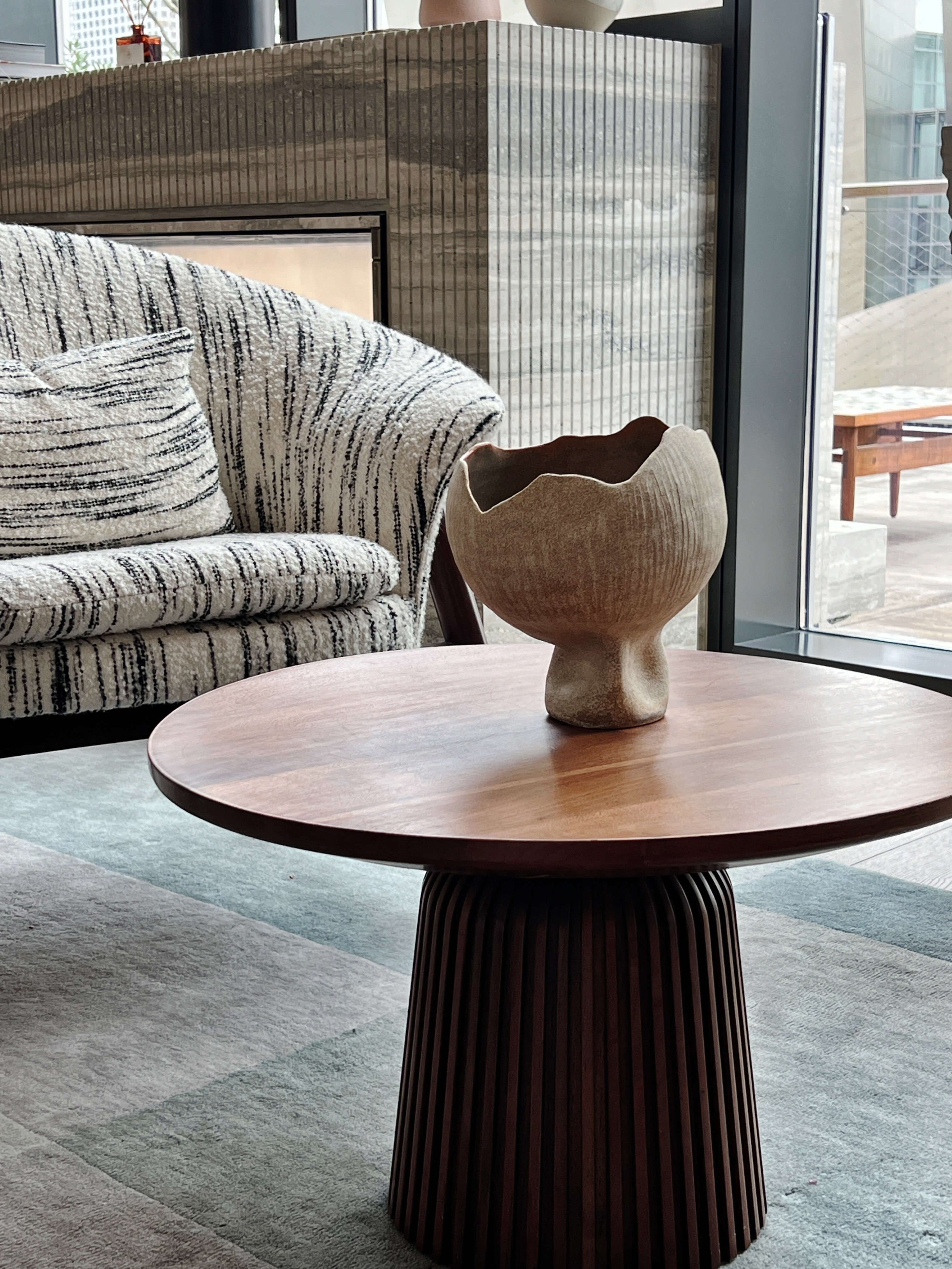 Decorative ceramic vase with an organic, uneven shape.