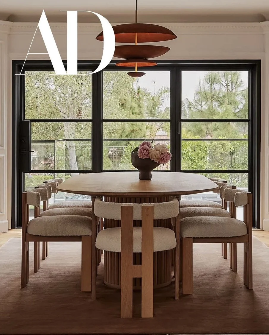 Sculptural ceramic vase by Anna Shipulina styled on a dining table in an interior featured in Architectural Digest