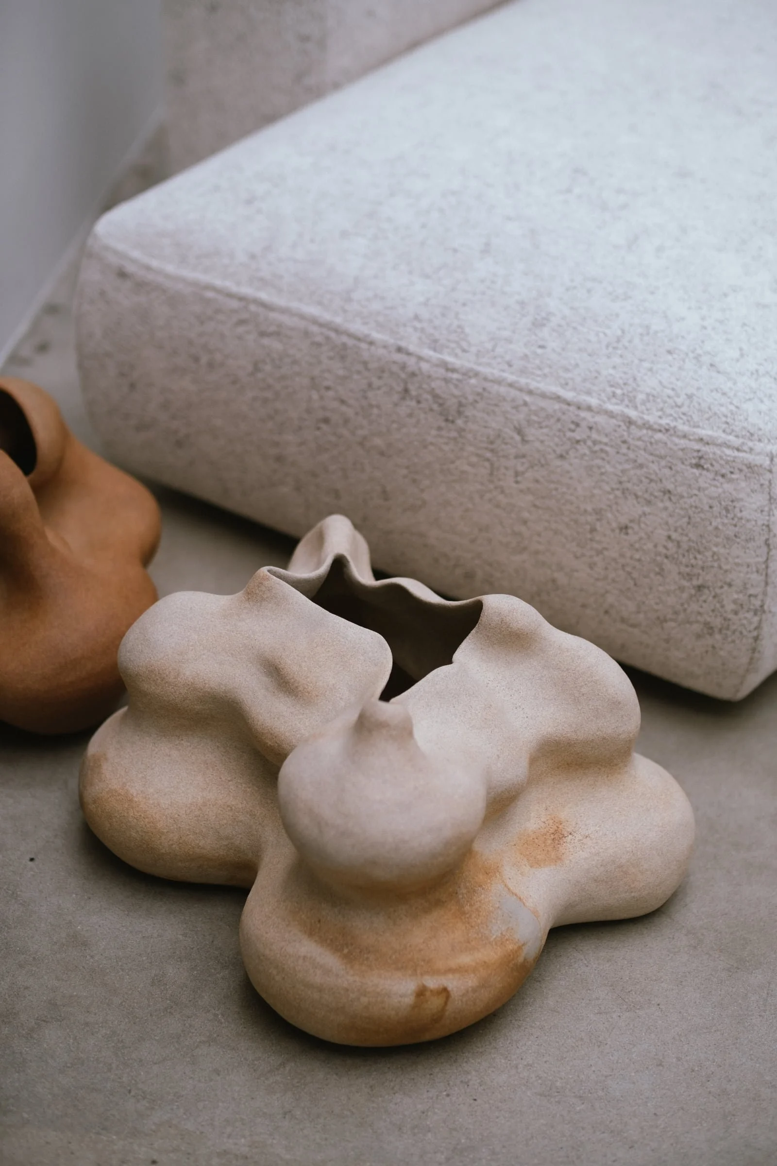 Sculptural ceramic vessels by Anna Shipulina in natural clay tones — fluid, organic forms suitable for hotel lobbies, restaurants, and other hospitality spaces.