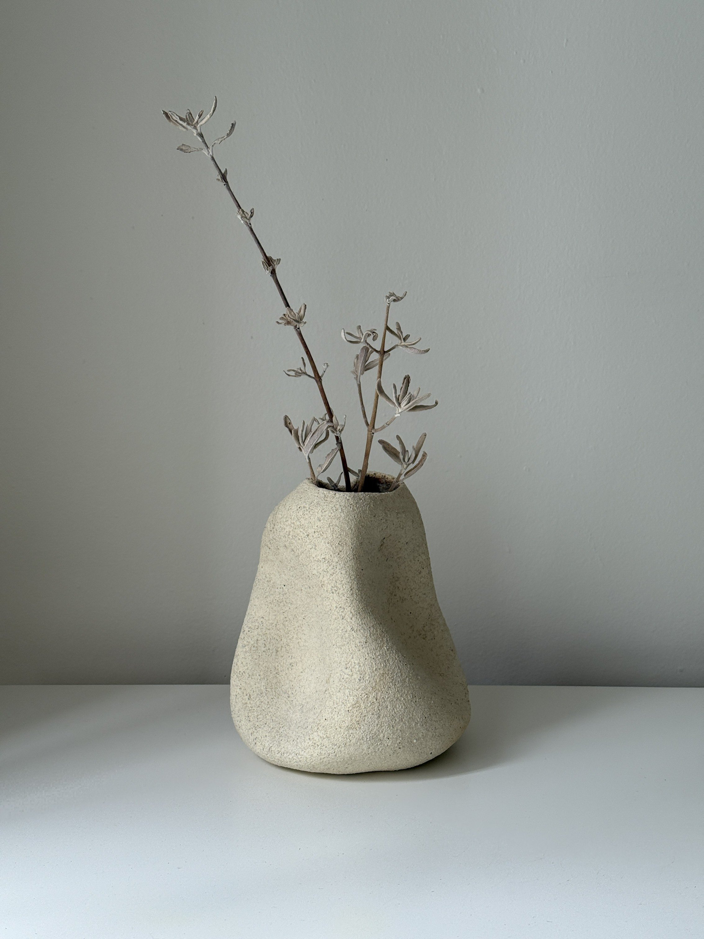 white organically shaped ceramic vase, it has textured surface