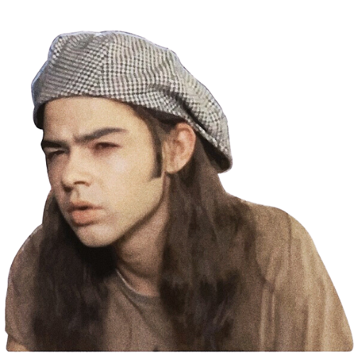 Person with long hair wearing a checkered beret, appearing curious or puzzled.