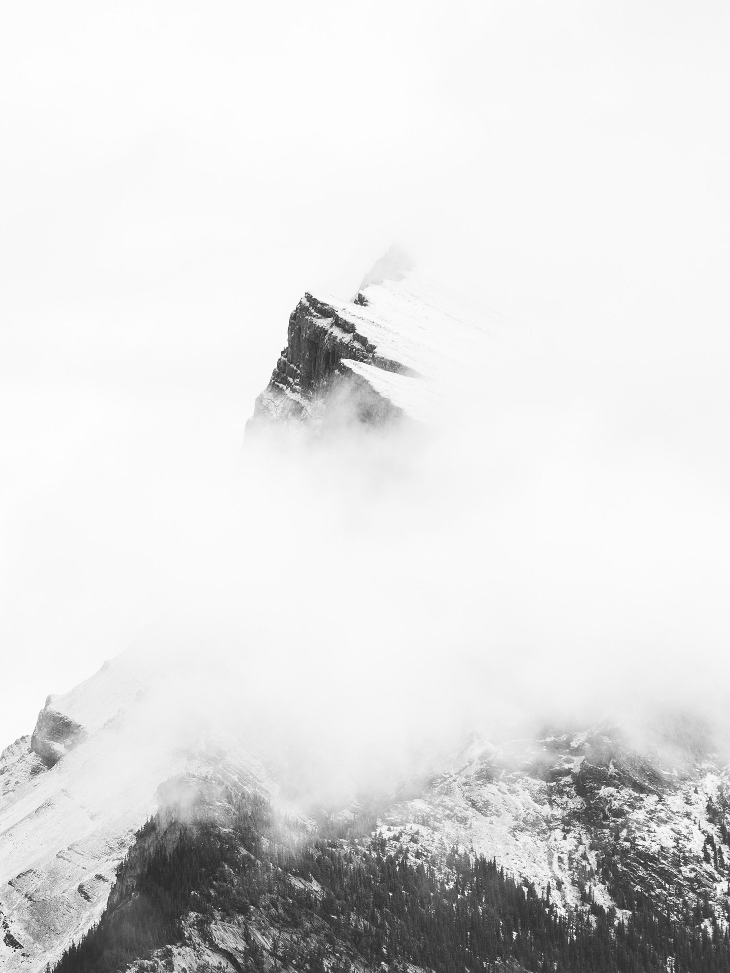 In the clouds. One of my favorite shots of Mt. Rundle in Alberta. It had been storming all day and I was driving back from the Icefields Parkway towards Banff. There was a gap in the storm and the towering peak of Mt. Rundle peered through the clouds