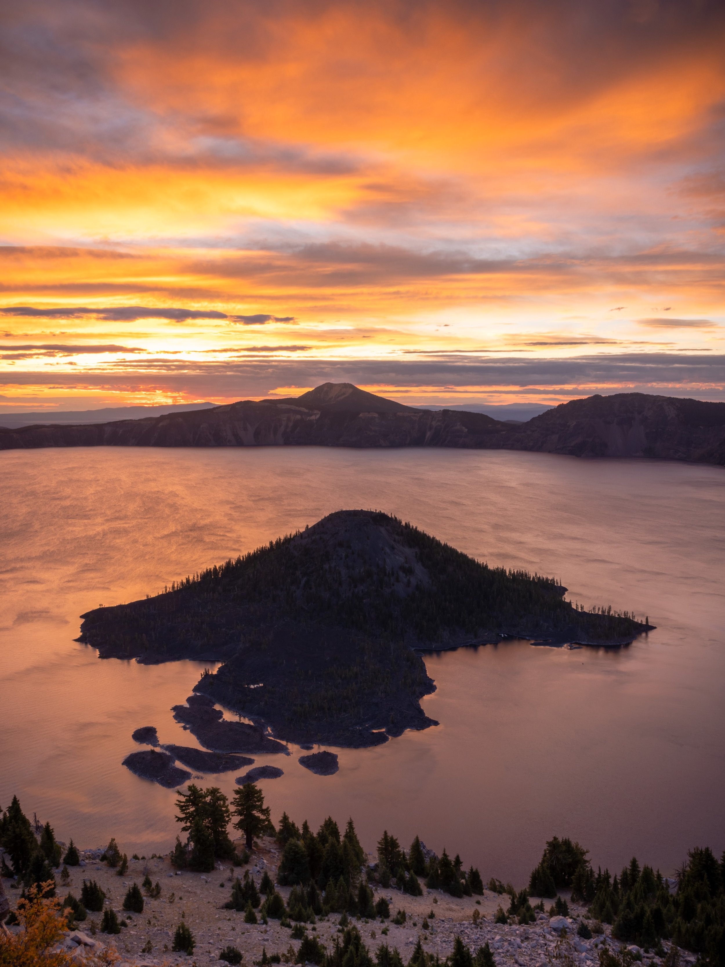 Morning at Crater Lake.

Wizard Island sits in solitude in Crater Lake, the deepest lake in the US. This is my favorite spot around the rim to catch sunrise. A quick hike up provides 365 degree views of Crater Lake and the surrounding Cascade mountai