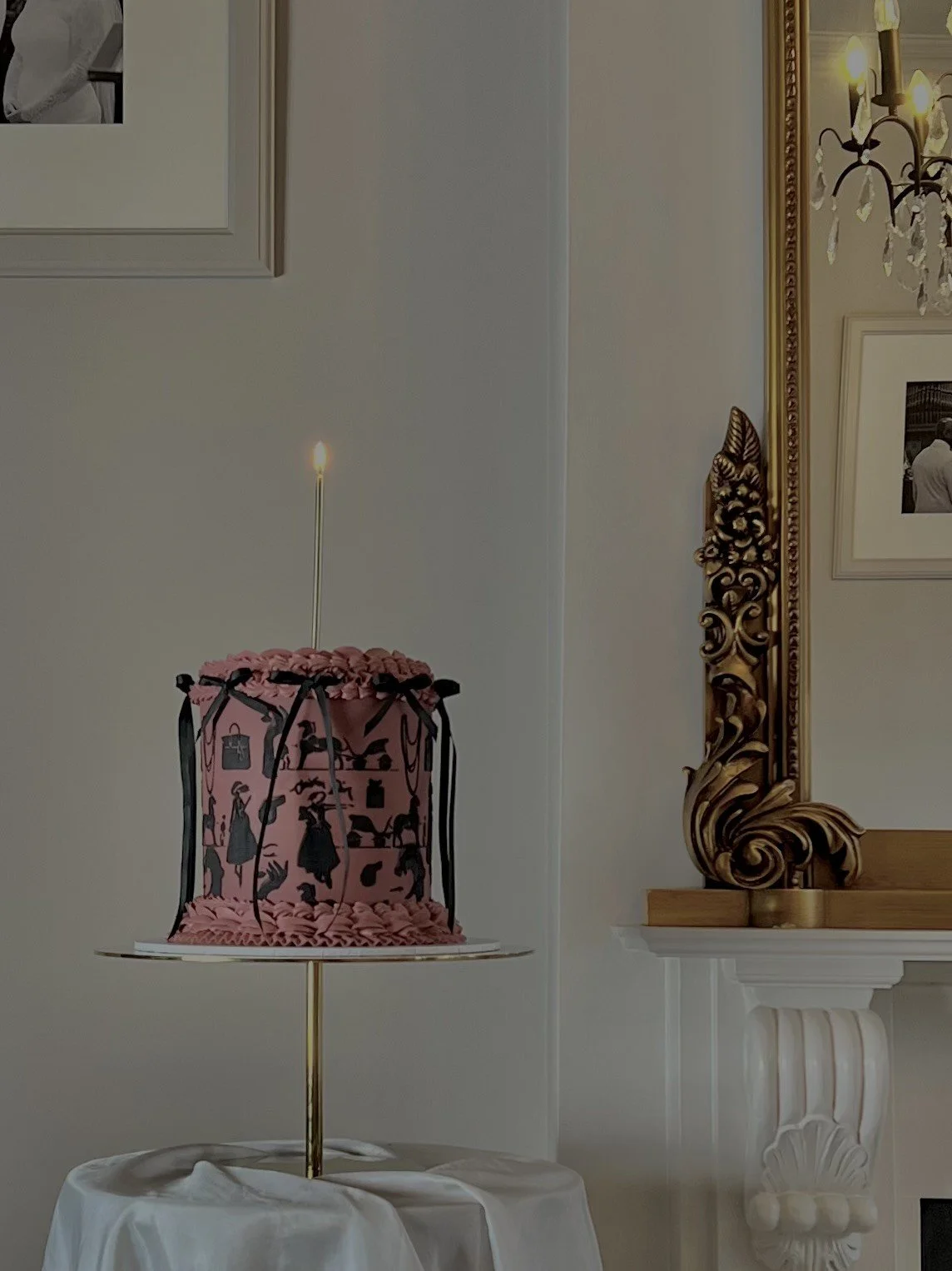 luxury designer birthday cake for birthday girl into her high end fashion. Dior birthday cake with tall candle..