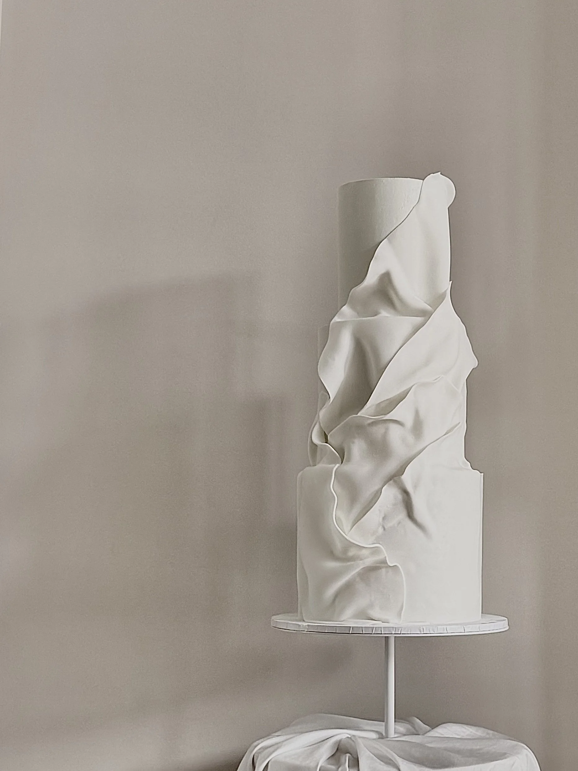 Modern wedding cake with fondant drapes for couples in Manchester and Cheshire.