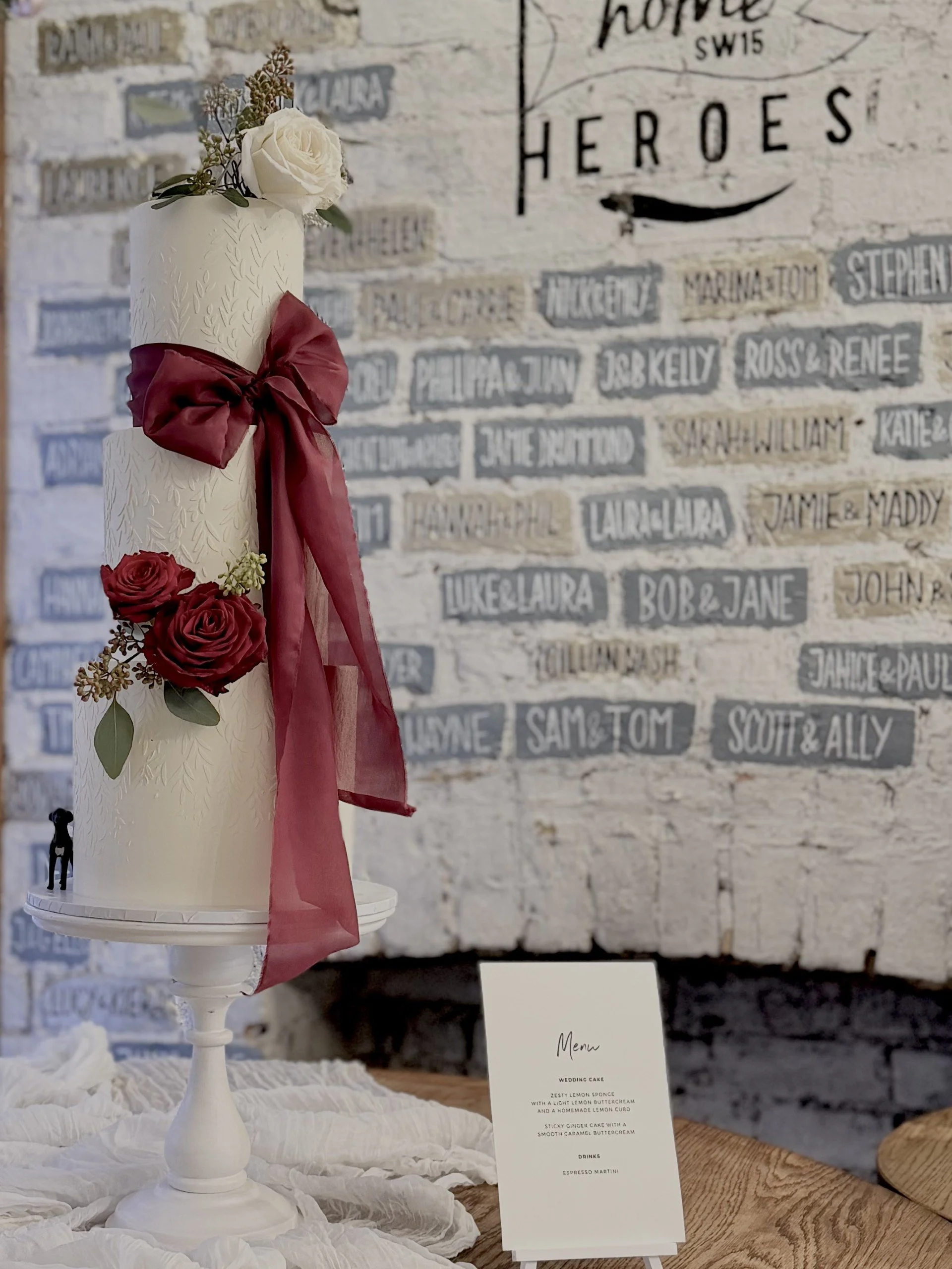 White and burgundy wedding cake with silk ribbon and red roses. wedding cakes in ALtrincham, Manchester and Cheshire.