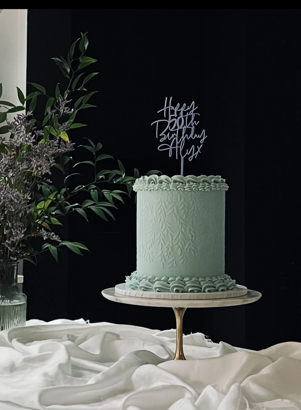 Vintage blue luxury bespoke birthday cake. 50th birthday cake with piping.