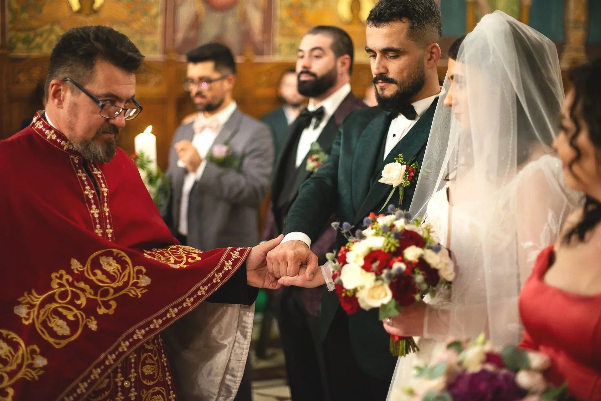mirele si mireasa sunt pusi de preot sa se tina de mana in cadrul ceremoniei religioase a nuntii