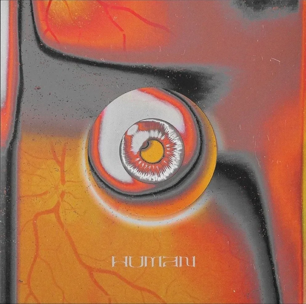 Close-up of a book cover featuring an abstract illustration of a human eye surrounded by orange, yellow, black, and red colors with the author's name 'HUMAN' at the bottom.