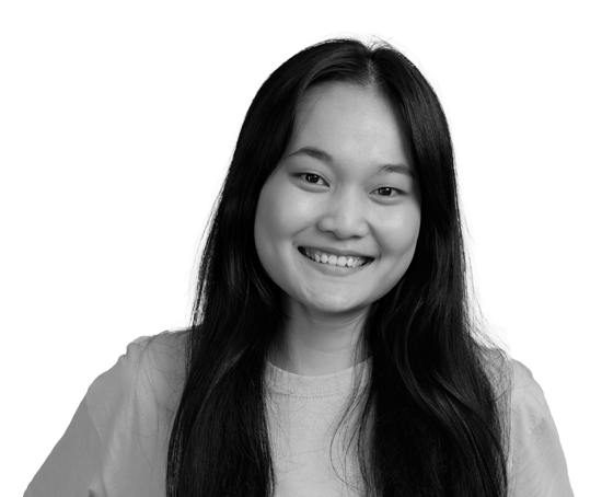 Black and white portrait of smiling young Asian woman with long hair, wearing a light-colored shirt.