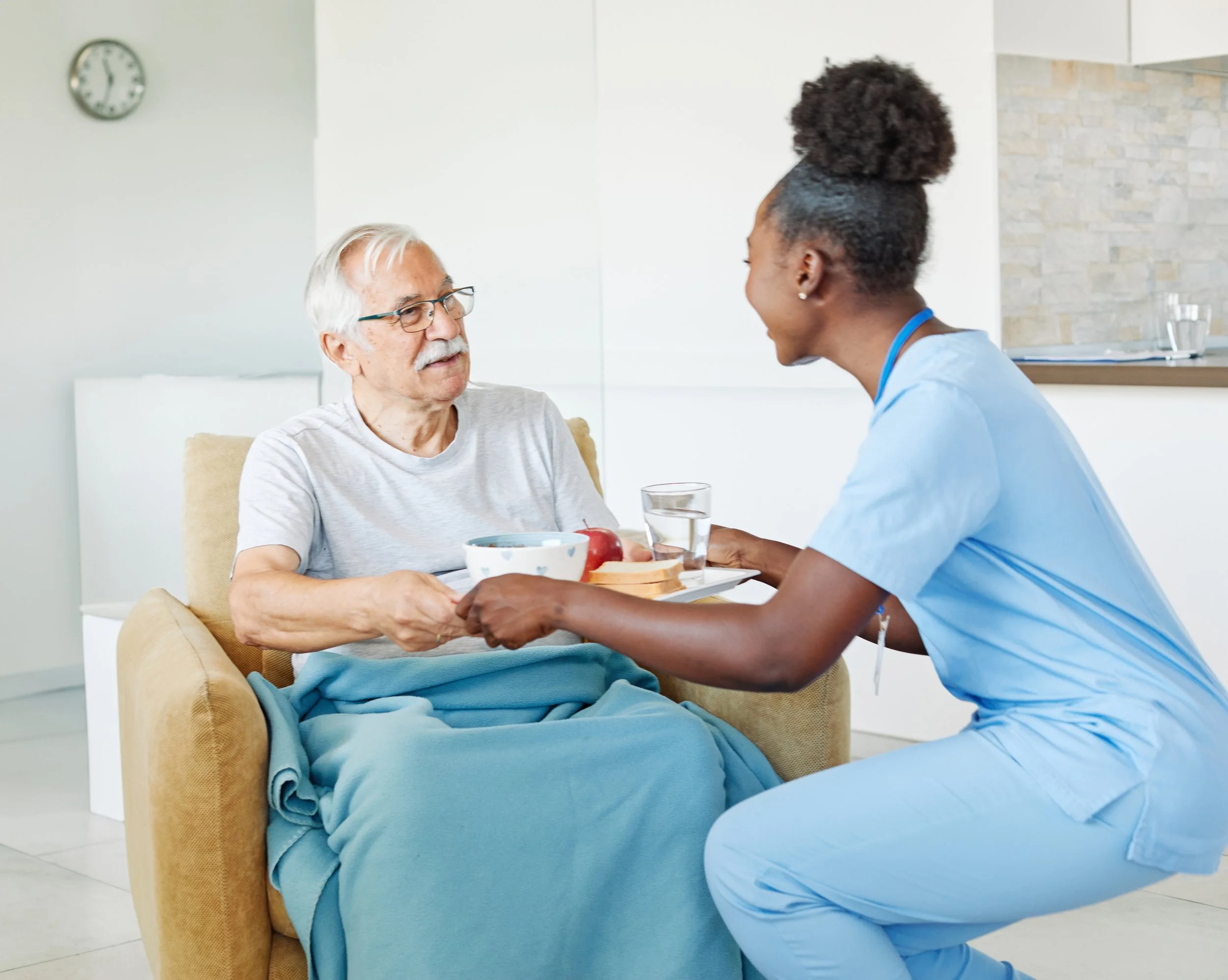 PSW handing food tray to senior man