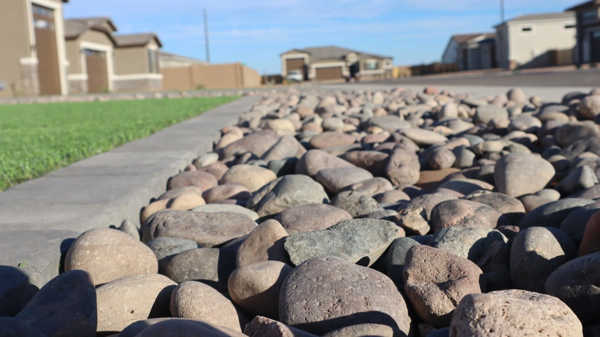 Rocks, turf and a paver border installed by Better Life Landscape and Design at this new build construction home near San Tan Valley, Arizona