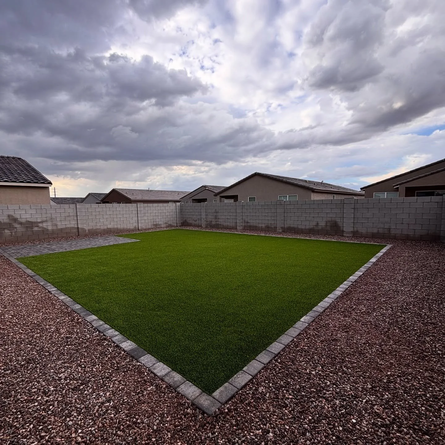 After | Turf, Rock & Pavers installation for a residential backyard in San Tan Valley, AZ by Better Life Landscape & Design.