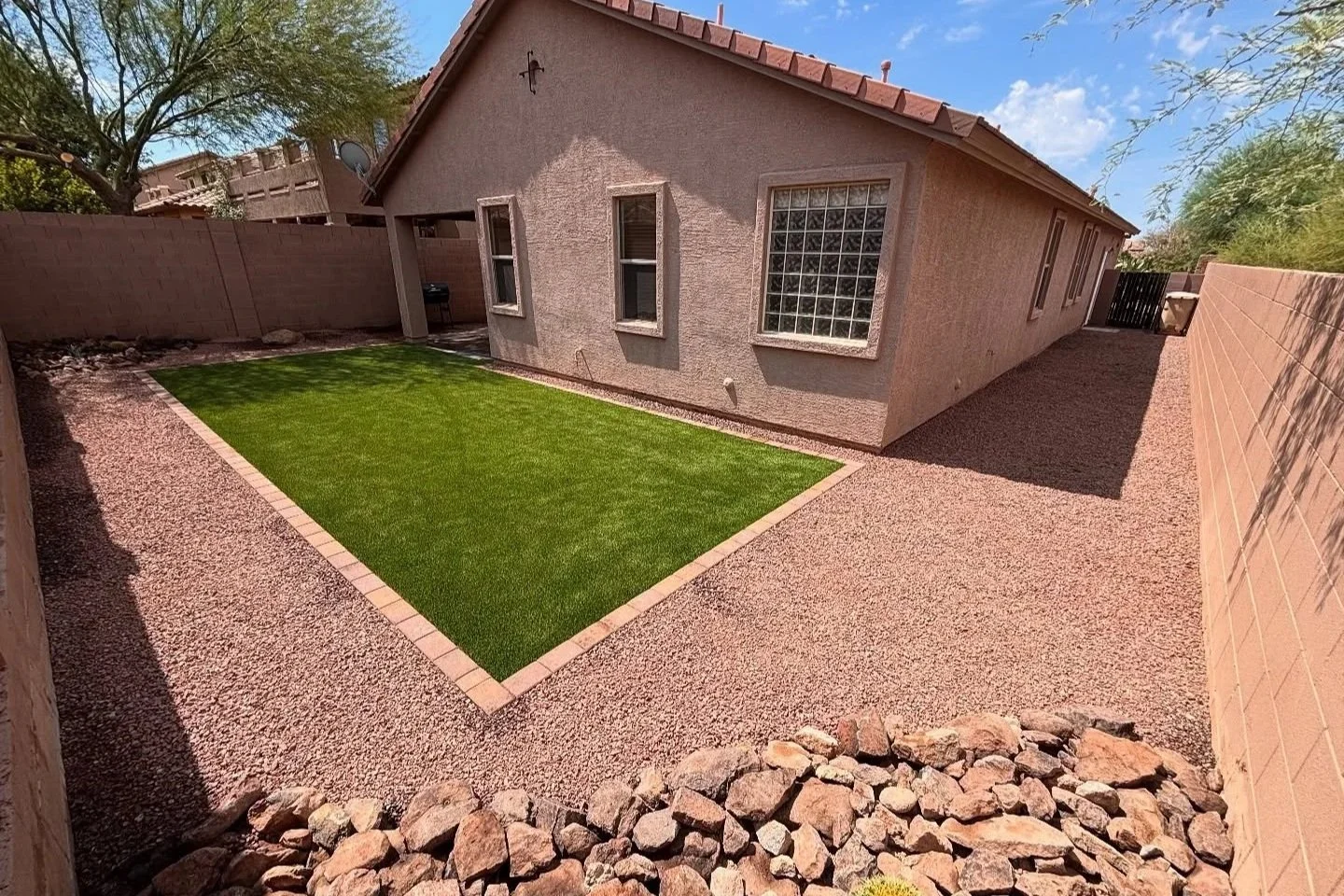 After | 3D Design into a Turf, Rock & Paver border project.
