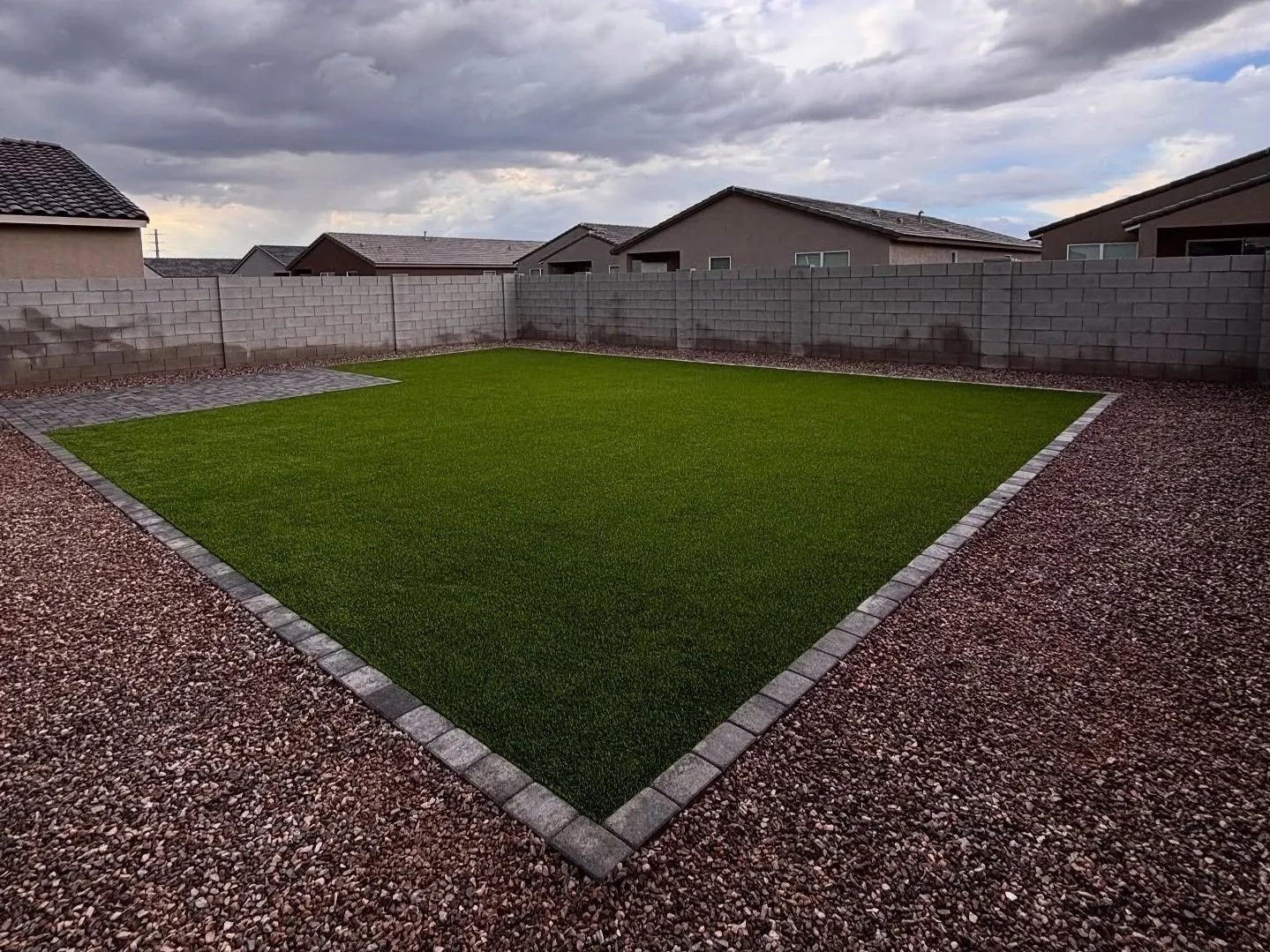 Gravel installed at this residential backyard in San Tan Valley, AZ by Better Life Landscape & Design along with turf and pavers.