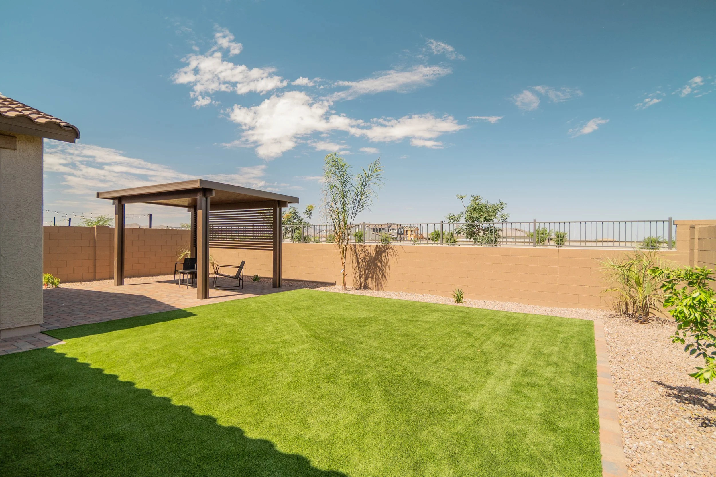 Tree Planting, Turf and Rocks installation services for a local residential project near Phoenix, Arizona by Better Life Landscape & Design.
