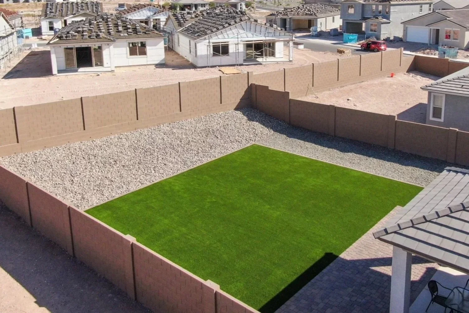Rocks, pavers and turf installed at this local new build residential home near Phoenix, Arizona by Better Life Landscape and Design.
