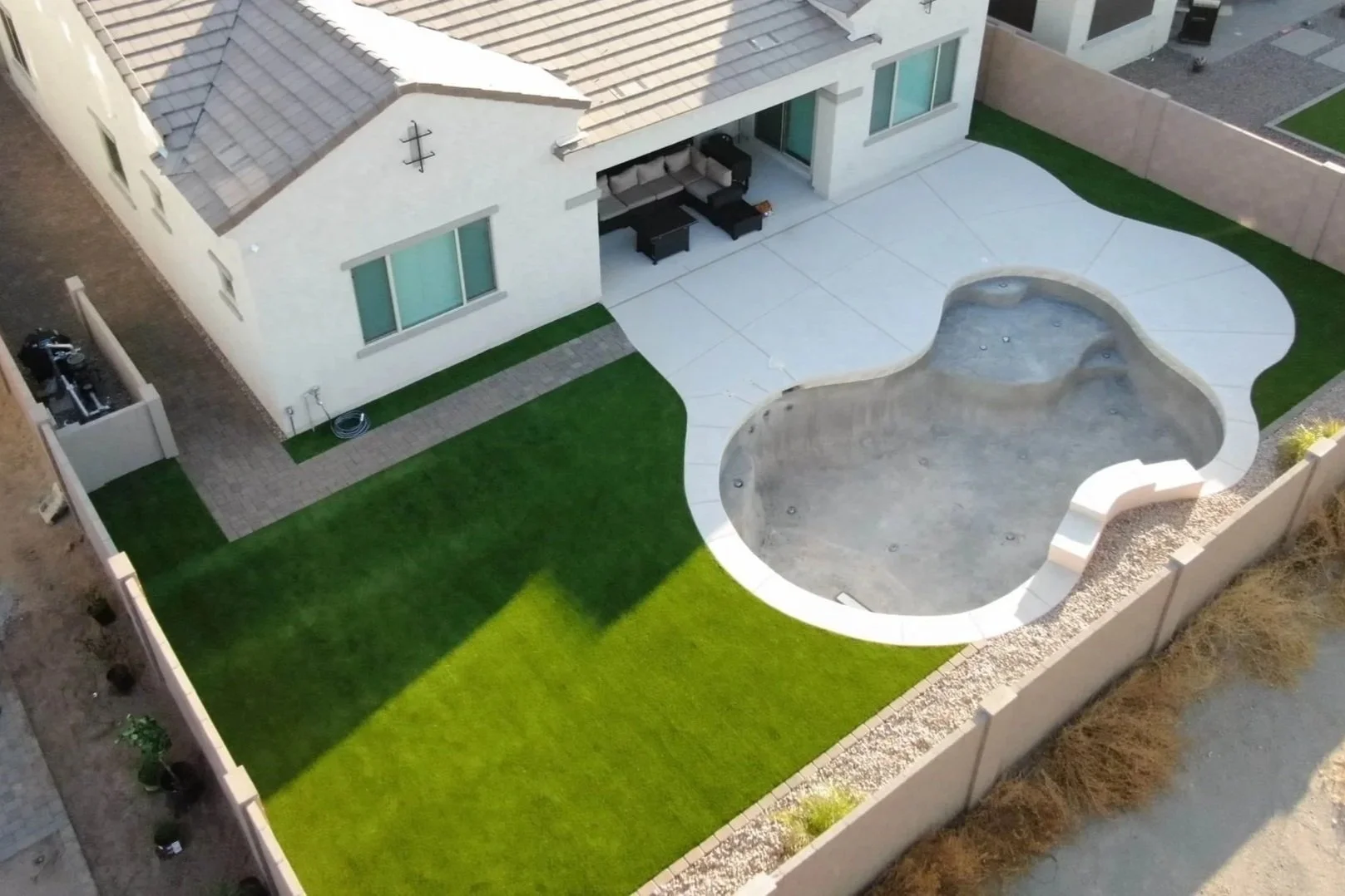 Turf, Rocks and Travertine installation services by Better Life Landscape and Design near Phoenix, Arizona for a local residential property.