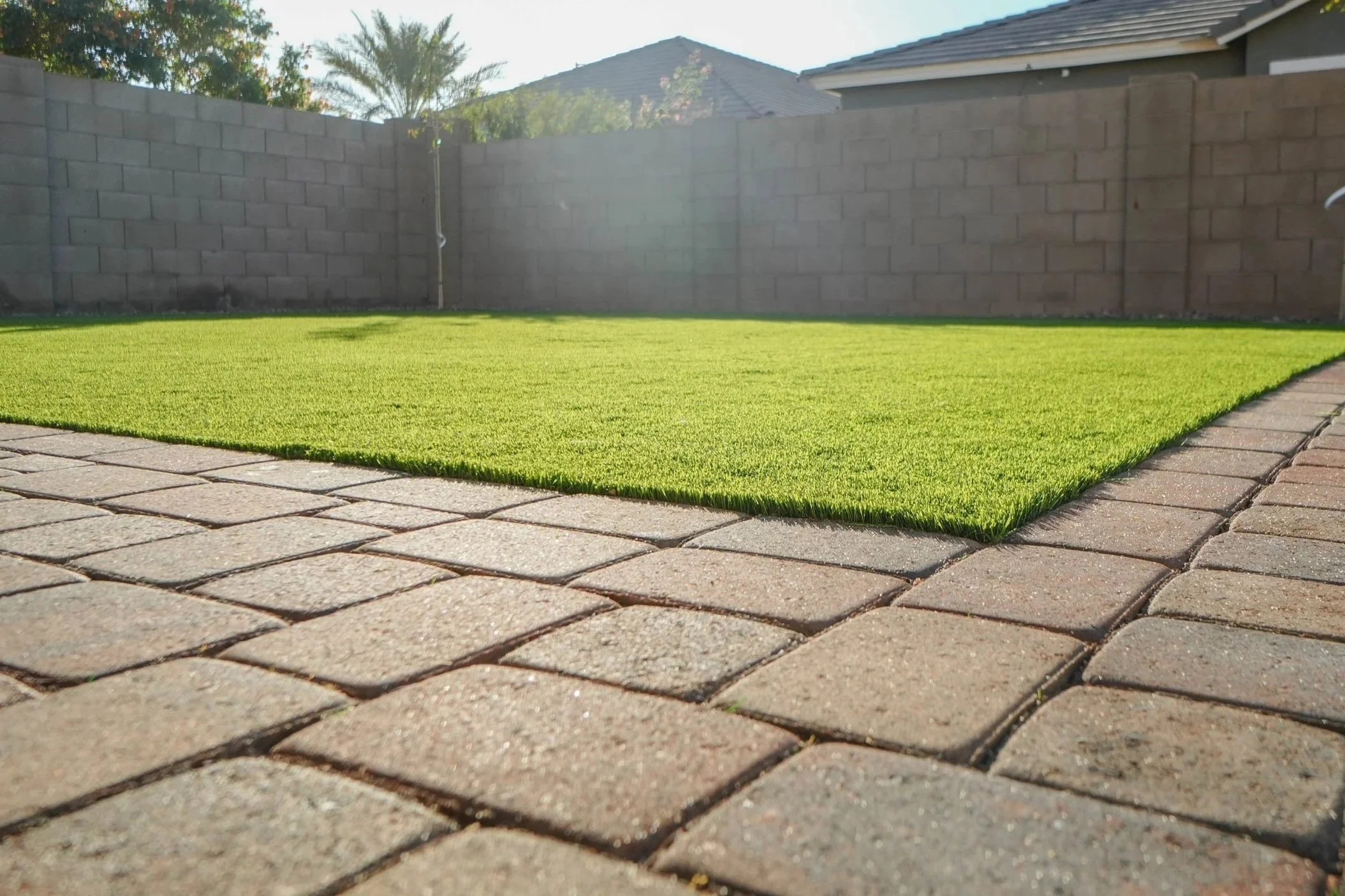 Turf and pavers installed at this local backyard in Phoenix by Better Life Landscape & Design