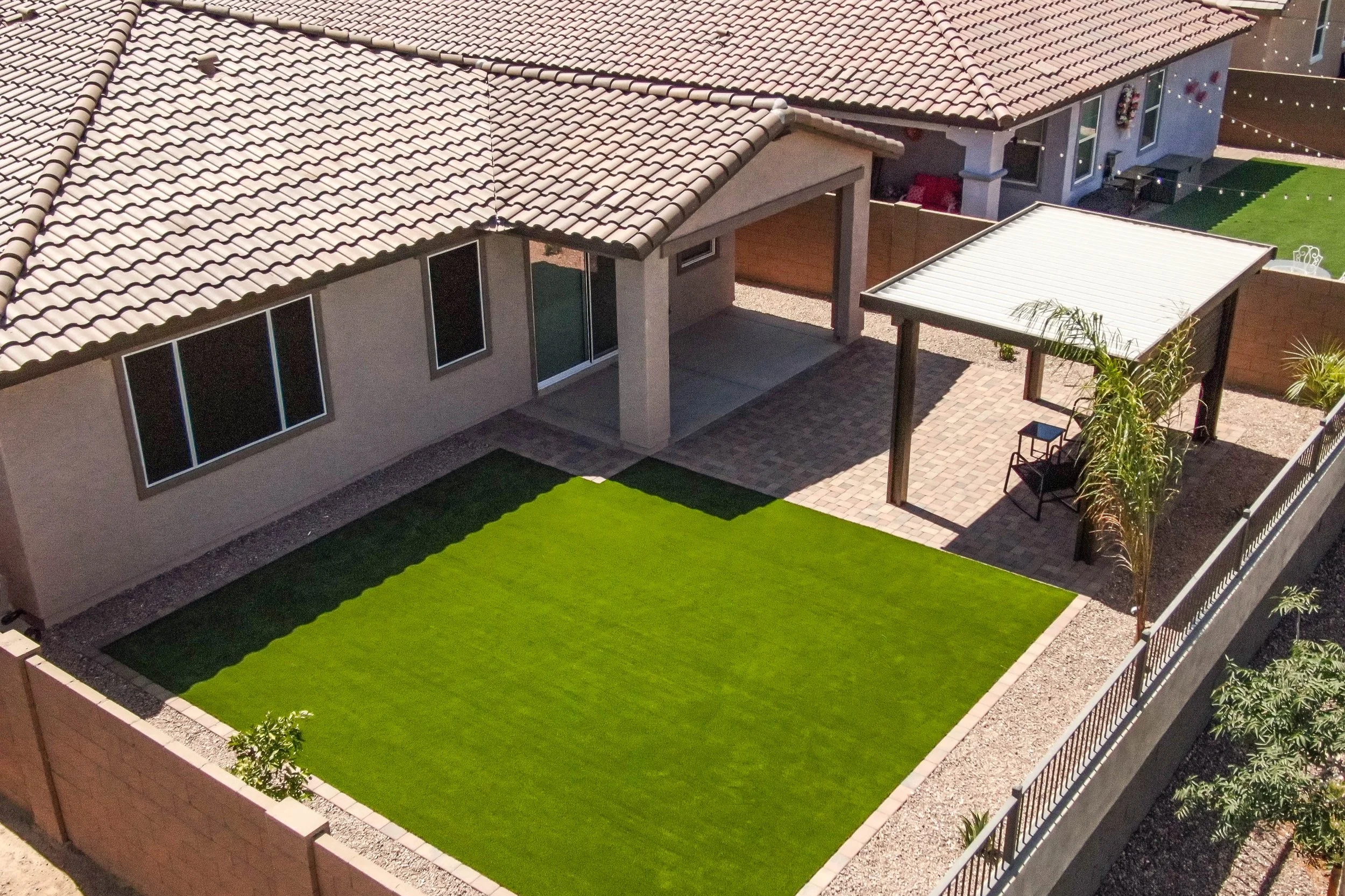 Turf, rocks and trees installed at this local home in Phoenix by Better Life Landscape & Design