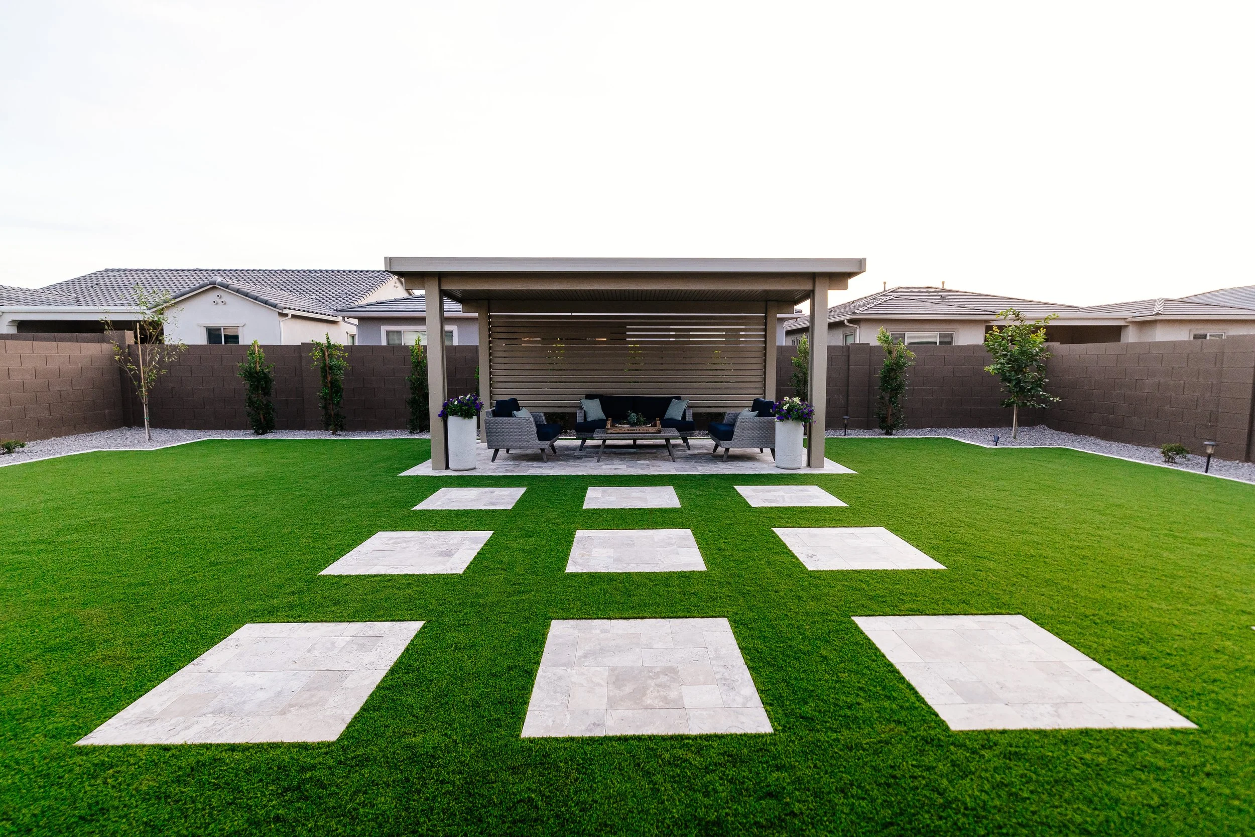 Turf, travertine, tree planting, pergola and rocks installed near Ahwatukee Phoenix by Better Life Landscape and Design