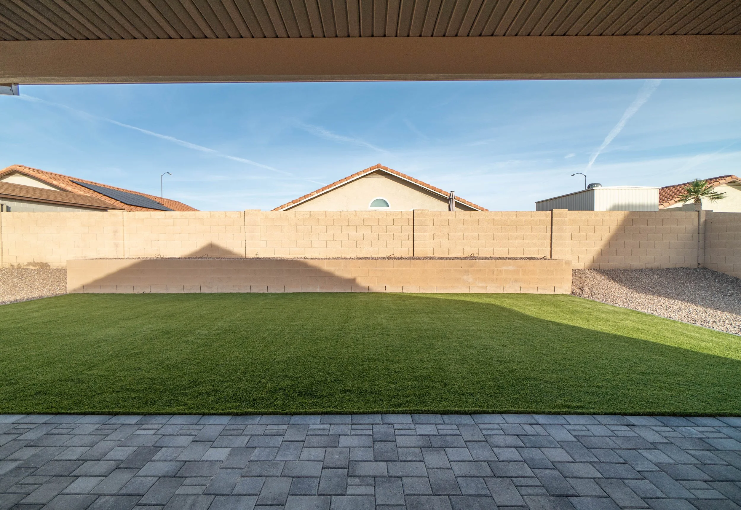 Turf, pavers and rocks installed at this local backyard by Better Life Landscape and Design near Scottsdale