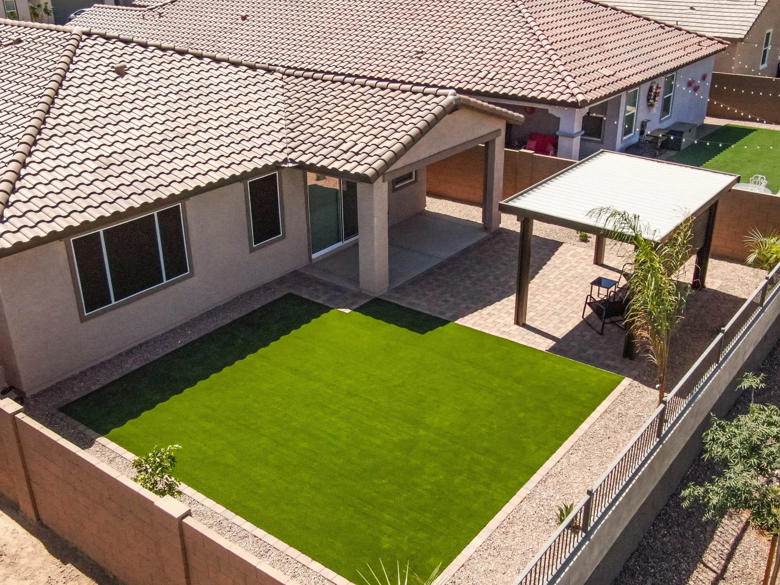 Turf, rocks and trees installed at this local home in Phoenix by Better Life Landscape & Design