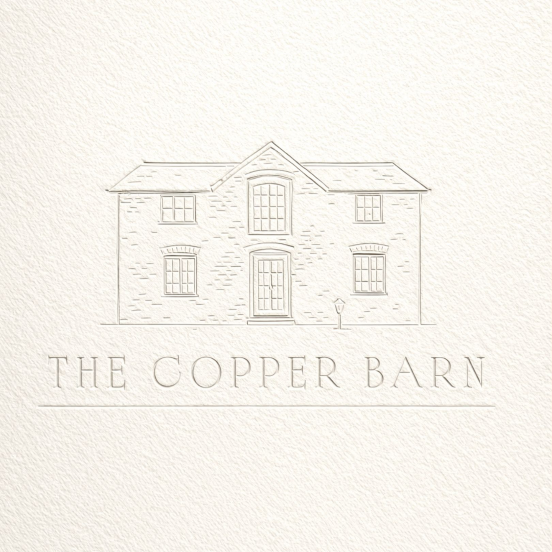 Embossed line drawing of a two-story house with the text "The Copper Barn" underneath.