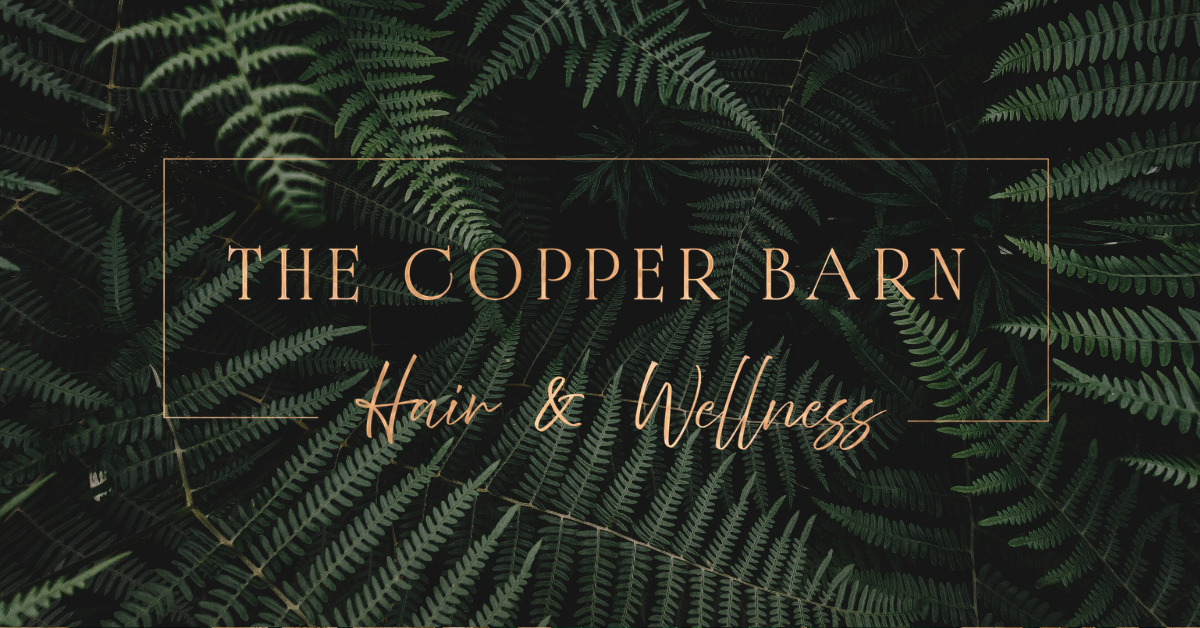 A dark background of green fern leaves with text overlay that reads "The Copper Barn Hair & Wellness" in elegant fonts.