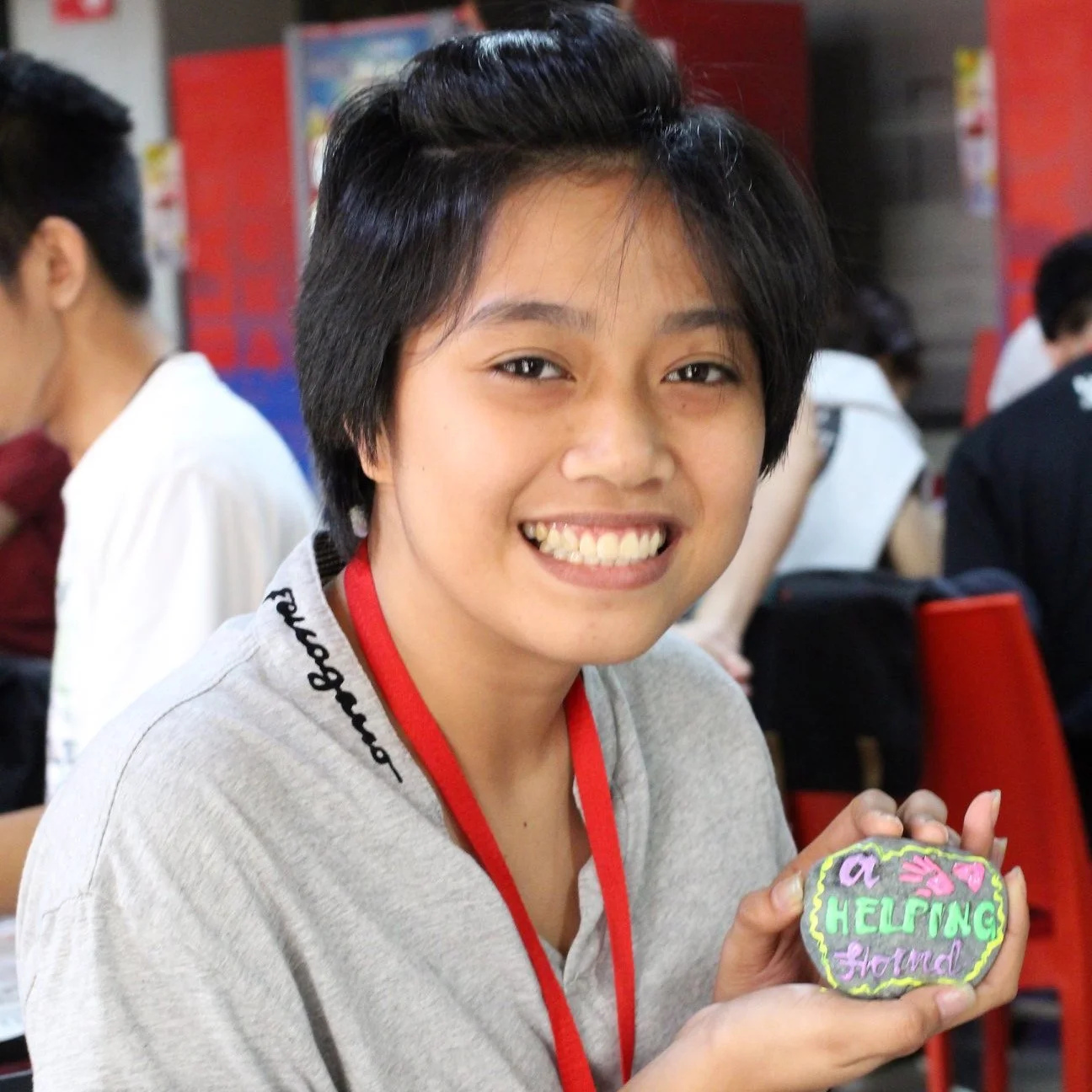 Filipina student holding a legacy stone