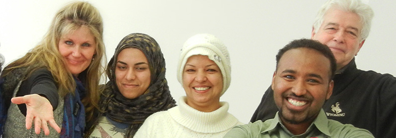 Two women from Mauritania smiling, one wearing a hijab and the other wearing a white knit hat, after graduating from corePurpose1.0