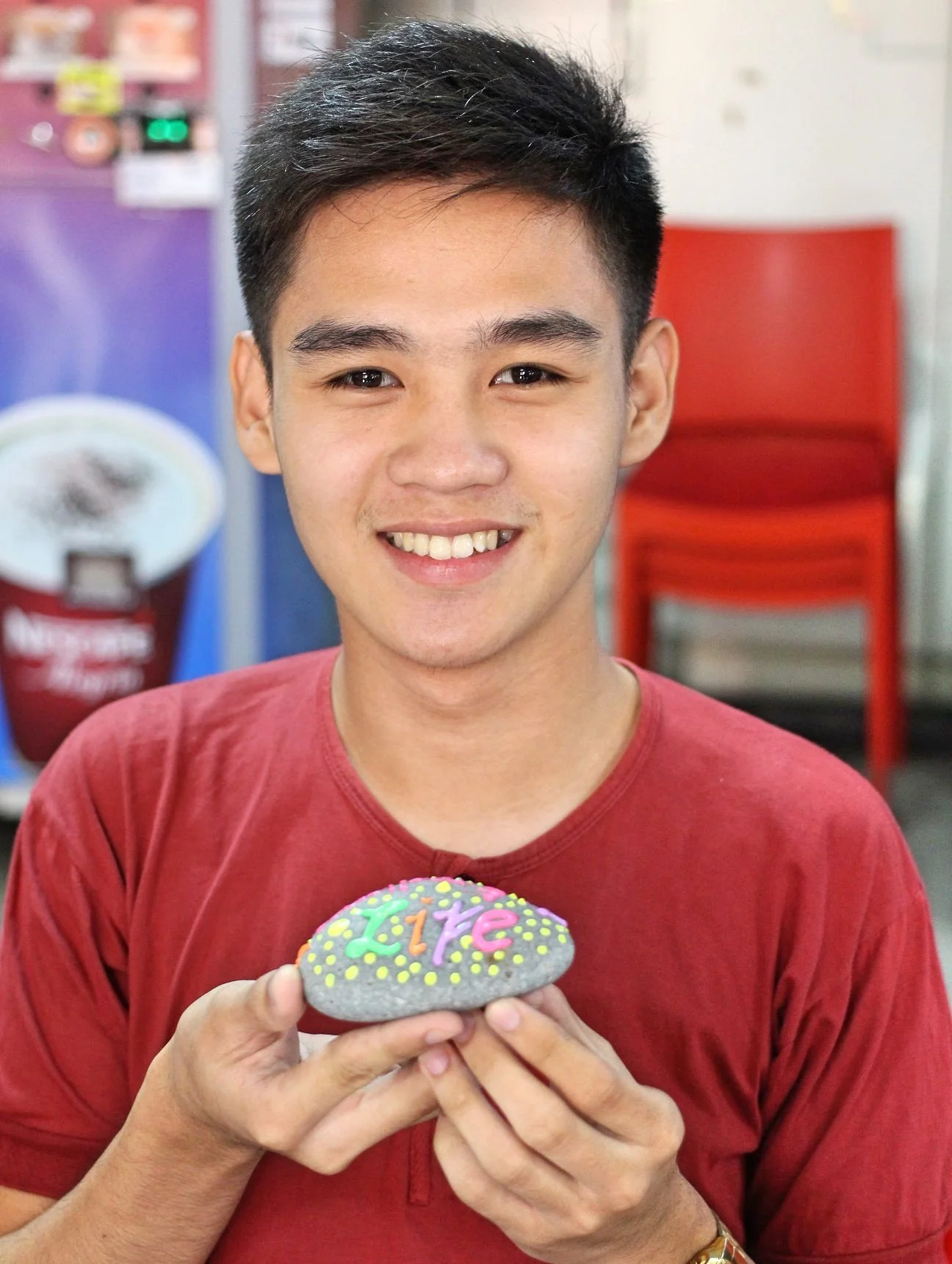 Filipino student holding a legacy stone